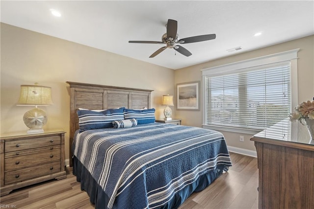 bedroom with wood-type flooring and ceiling fan