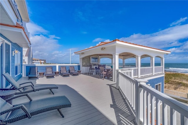 wooden terrace with a water view and a beach view