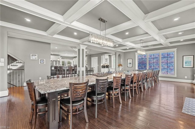 dining room with decorative columns, beamed ceiling, coffered ceiling, and dark wood-type flooring