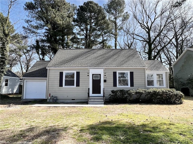 view of front of home featuring a front yard and a garage