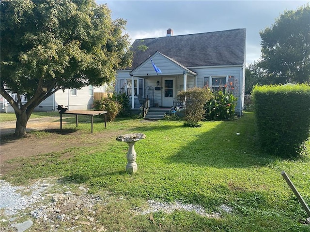 bungalow-style house with a front lawn and covered porch