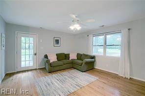 living room with ceiling fan and light hardwood / wood-style floors