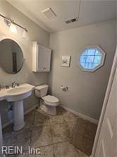 bathroom featuring tile patterned flooring and toilet