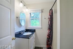 bathroom featuring vanity and a shower with curtain