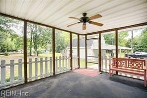 unfurnished sunroom featuring ceiling fan