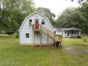 rear view of property featuring a yard