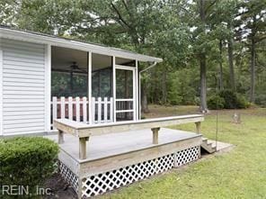 wooden terrace featuring a yard