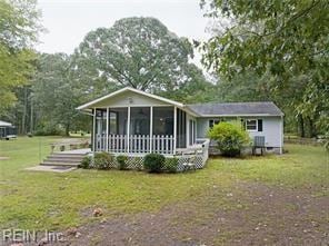 view of front of property featuring a sunroom and a front yard