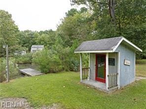 view of outbuilding featuring a lawn