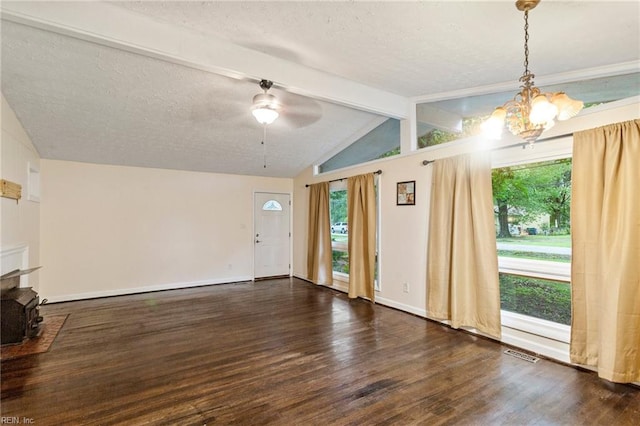 unfurnished living room with a textured ceiling, ceiling fan with notable chandelier, lofted ceiling with beams, and dark hardwood / wood-style floors