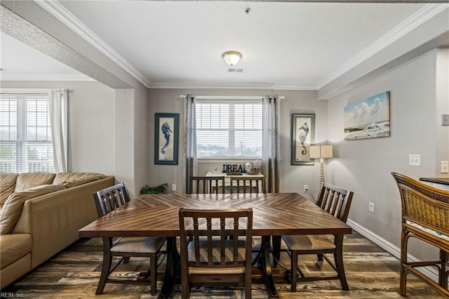 dining area with ornamental molding and dark wood-type flooring