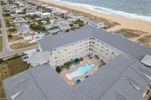 drone / aerial view with a beach view and a water view