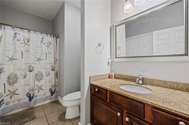 bathroom with a shower with curtain, vanity, toilet, and tile patterned floors