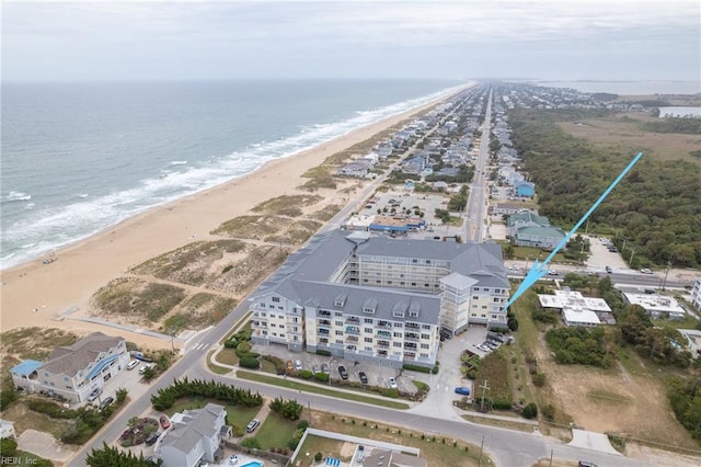 birds eye view of property with a water view and a beach view