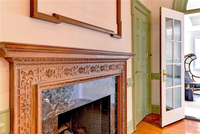 room details with hardwood / wood-style floors and a fireplace