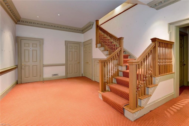 stairway featuring carpet flooring