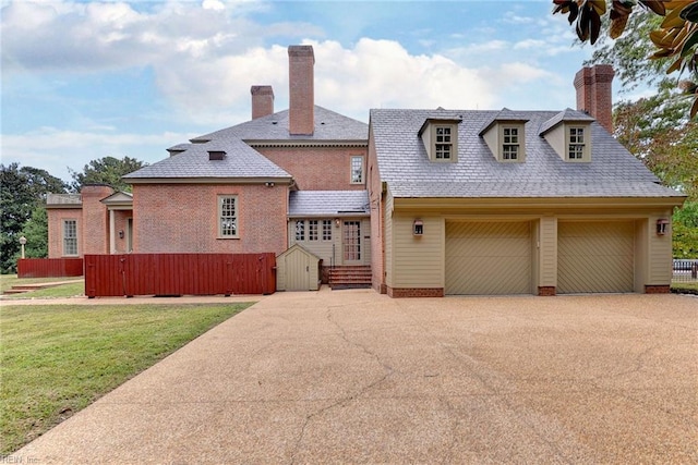 view of front of property featuring a garage and a front lawn