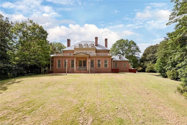 rear view of property featuring a yard