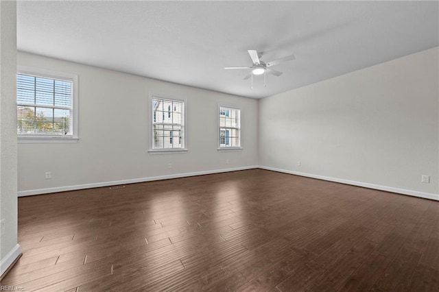 empty room with ceiling fan and dark hardwood / wood-style floors