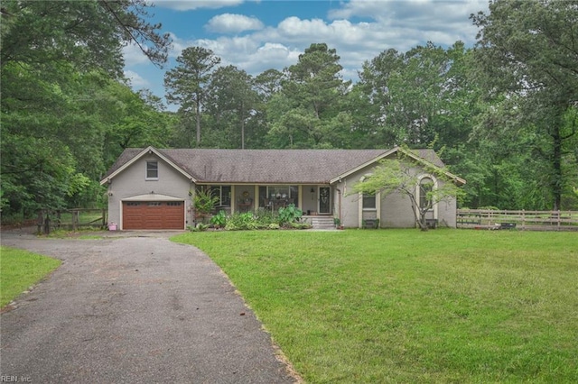 ranch-style home with a garage and a front lawn