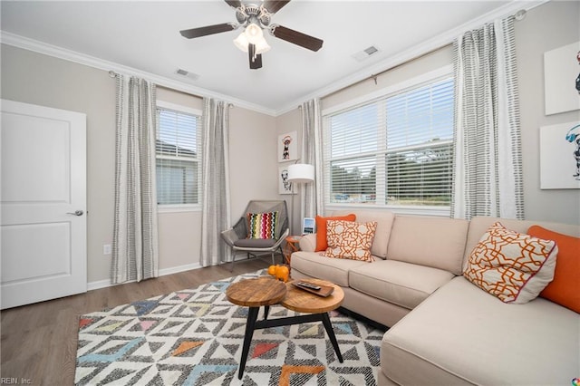 living room with ornamental molding, ceiling fan, and hardwood / wood-style flooring