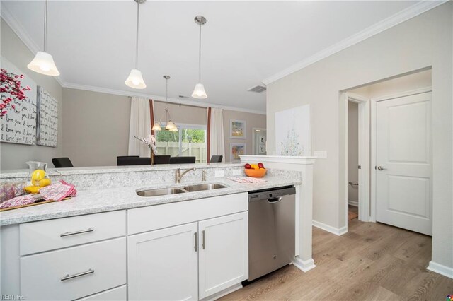 kitchen with white cabinets, pendant lighting, light hardwood / wood-style flooring, stainless steel dishwasher, and sink