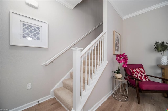 stairway featuring wood-type flooring and ornamental molding