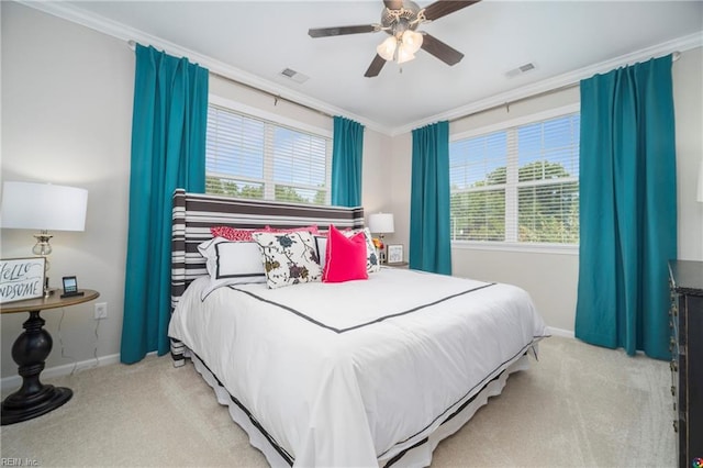 carpeted bedroom with ceiling fan and crown molding