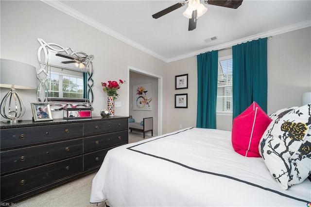 carpeted bedroom featuring ornamental molding and ceiling fan