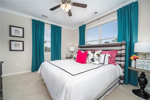 bedroom with ceiling fan, light colored carpet, and multiple windows