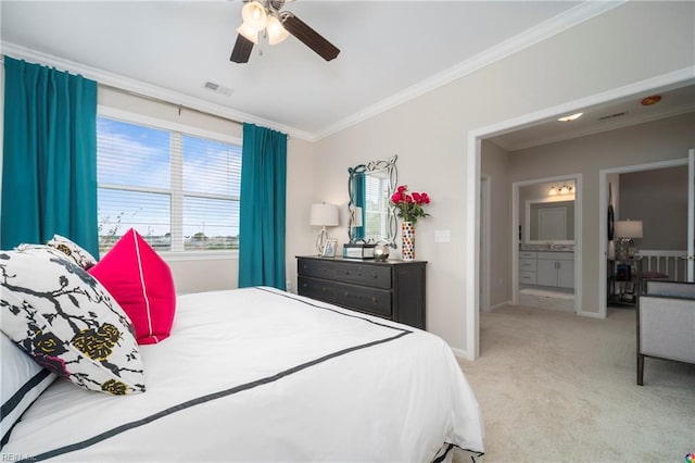 bedroom featuring crown molding, light carpet, ceiling fan, and ensuite bathroom