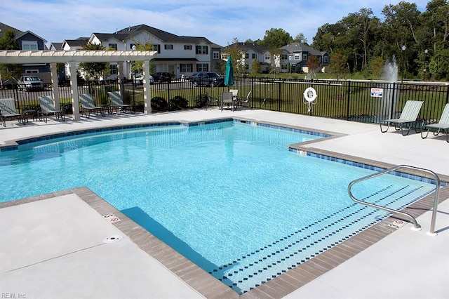 view of swimming pool featuring a patio and a yard