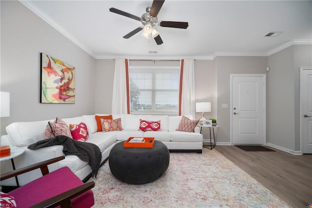 living room with ceiling fan, light wood-type flooring, and ornamental molding