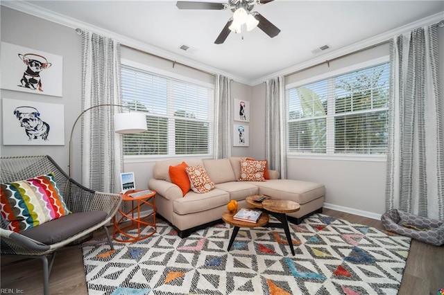 living room with ceiling fan, crown molding, and hardwood / wood-style floors