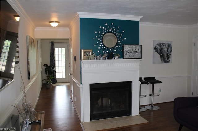 living room featuring ornamental molding and dark wood-type flooring