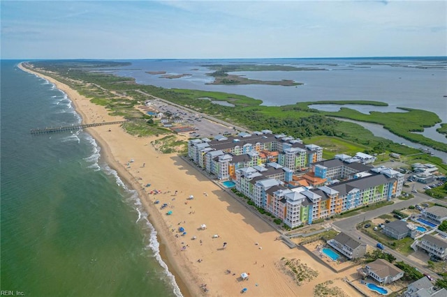 aerial view with a water view and a beach view