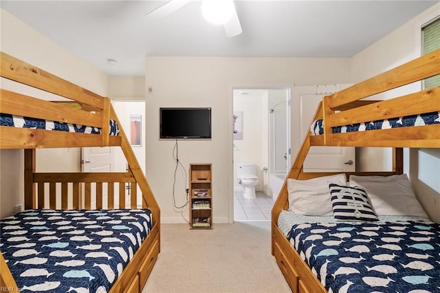 bedroom featuring ensuite bath, ceiling fan, and light colored carpet