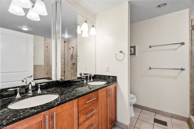 bathroom with vanity, toilet, tile patterned floors, and an enclosed shower