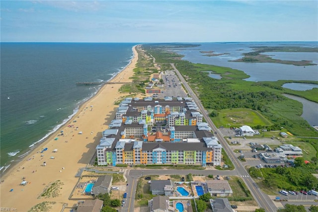 drone / aerial view featuring a view of the beach and a water view