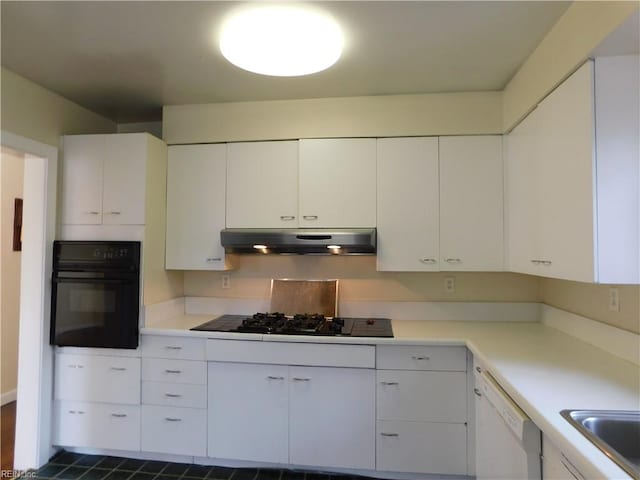 kitchen featuring black appliances and white cabinetry