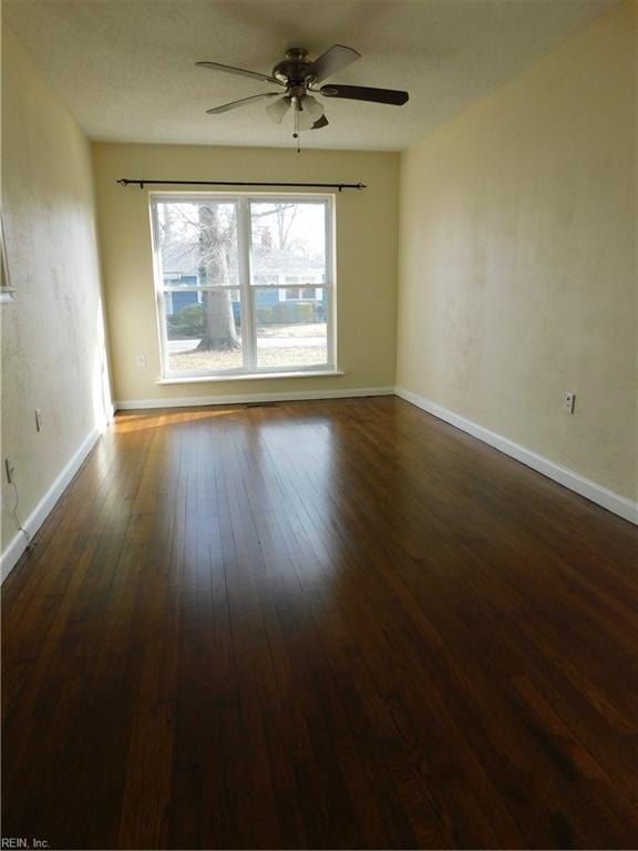 unfurnished room featuring ceiling fan and dark hardwood / wood-style flooring