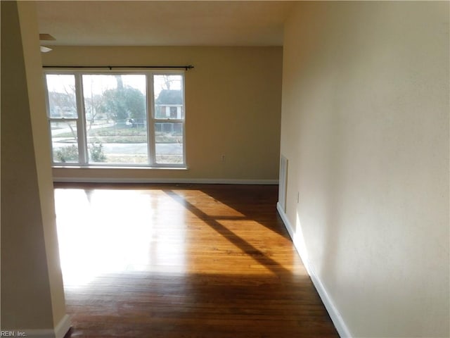 unfurnished room with dark hardwood / wood-style floors