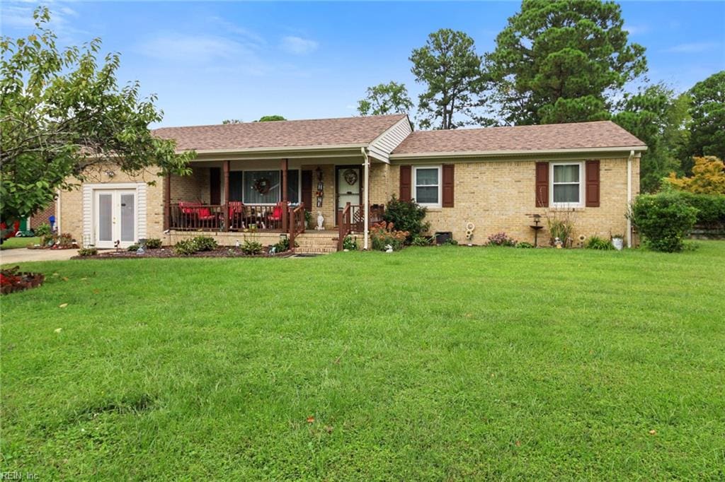 single story home featuring a front yard and covered porch