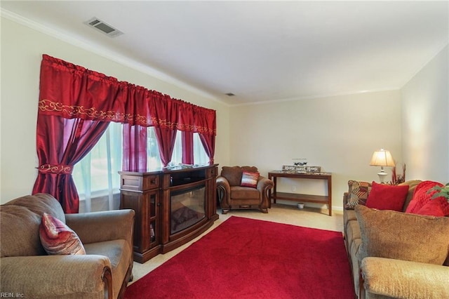 carpeted living room featuring ornamental molding