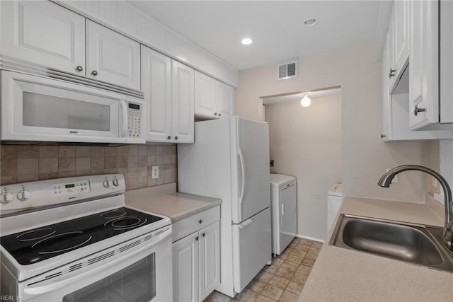 kitchen featuring sink, white appliances, white cabinetry, independent washer and dryer, and decorative backsplash