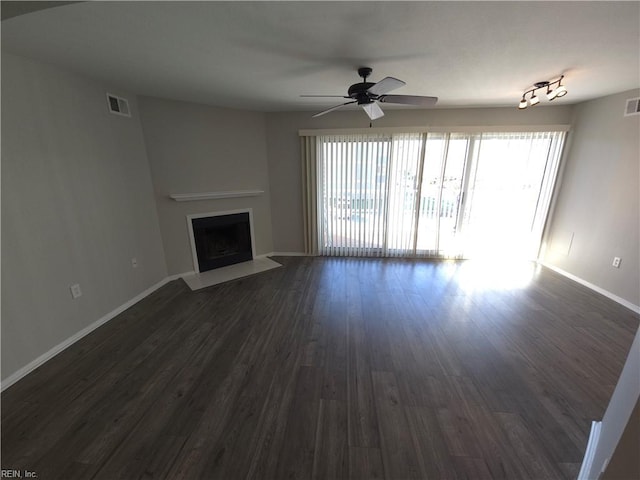 unfurnished living room featuring dark hardwood / wood-style floors and ceiling fan