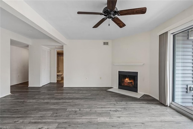 unfurnished living room with wood-type flooring and ceiling fan