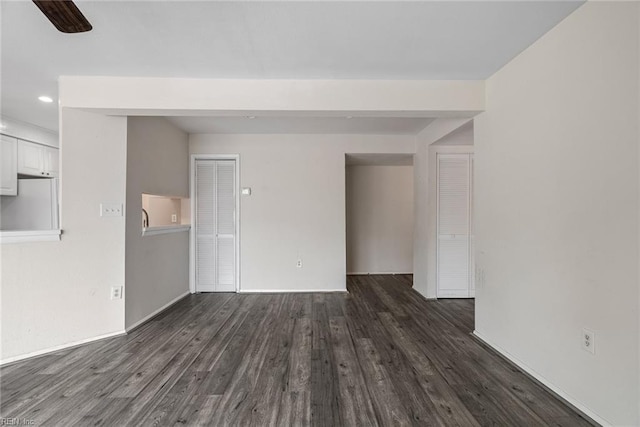 unfurnished living room featuring dark hardwood / wood-style floors