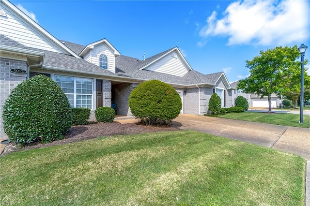 view of front of house featuring a front yard and a garage