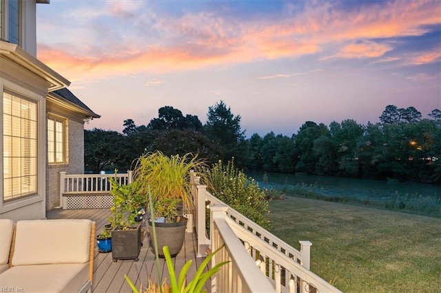 exterior space featuring a lawn and a water view